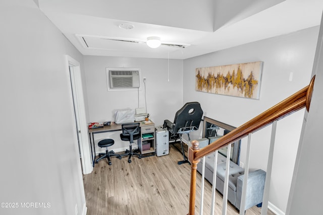 office featuring a wall mounted air conditioner and light hardwood / wood-style flooring