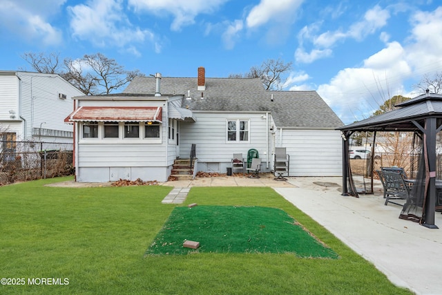 rear view of house with a gazebo, a patio, and a lawn