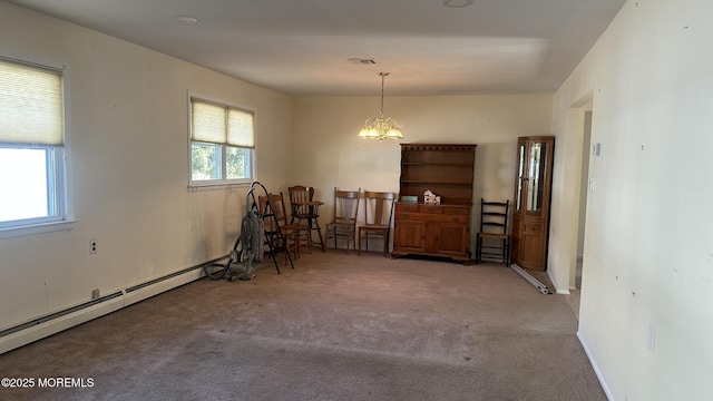 dining room with baseboard heating, carpet flooring, and a notable chandelier