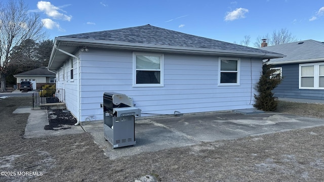 back of property with a patio