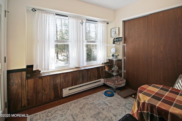 sitting room with a baseboard radiator and dark hardwood / wood-style floors