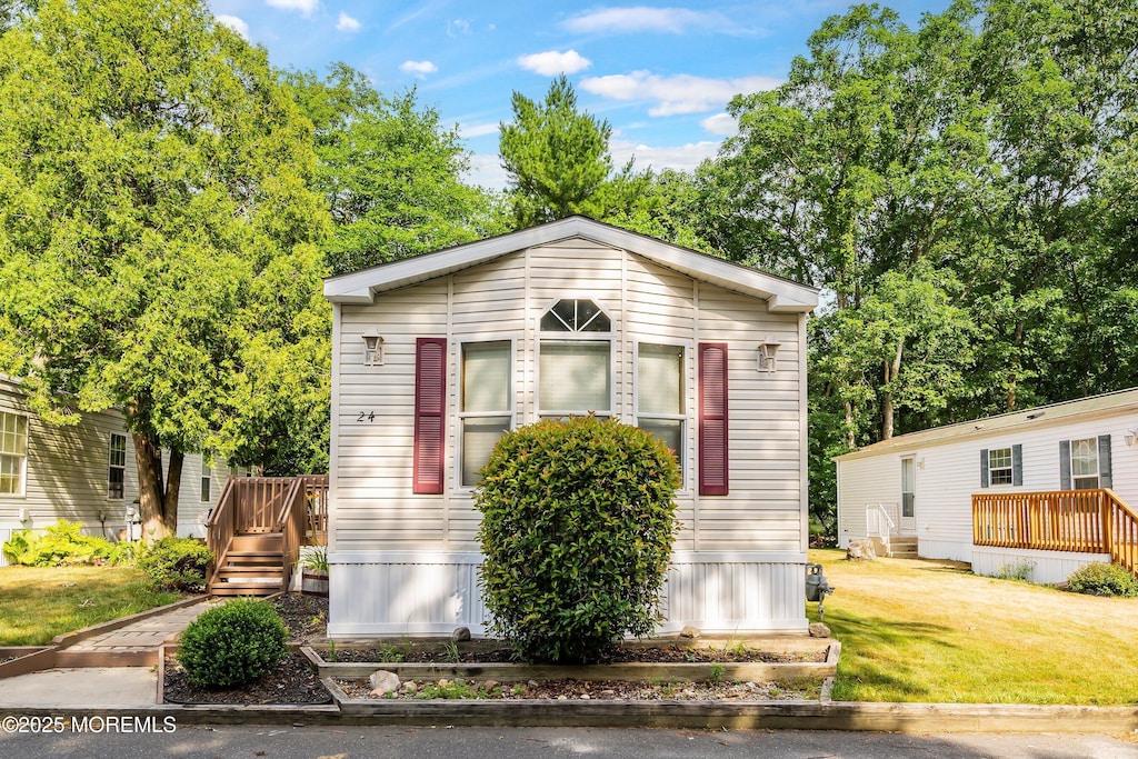 view of front of home featuring a front yard and a deck
