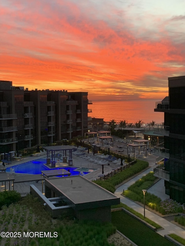 view of swimming pool featuring a water view