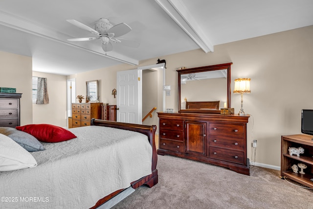 bedroom with beamed ceiling, ceiling fan, and light carpet