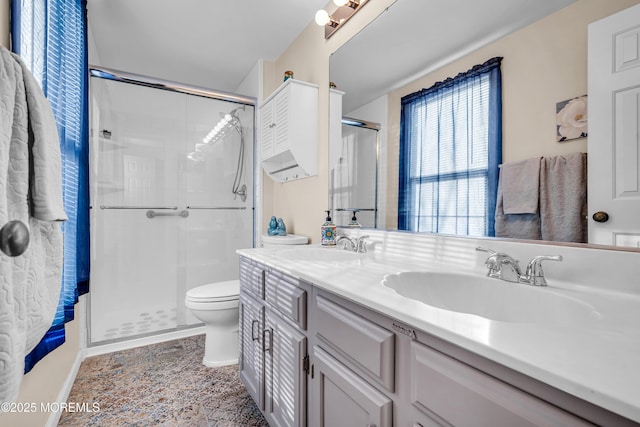 bathroom featuring vanity, tile patterned floors, toilet, and walk in shower