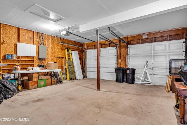 garage with a garage door opener and electric panel