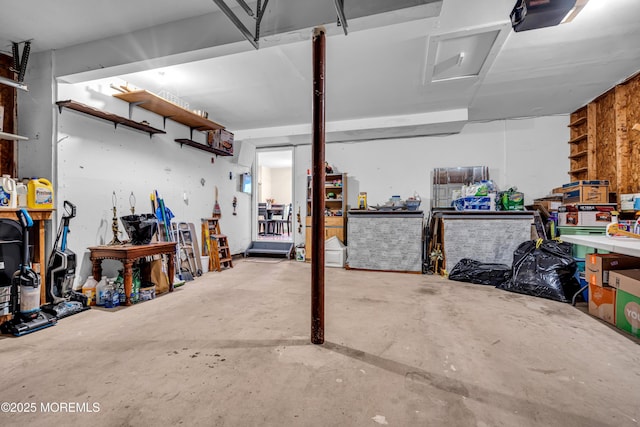 garage with a garage door opener and a workshop area