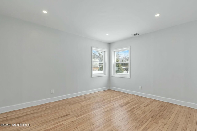 empty room with light hardwood / wood-style floors