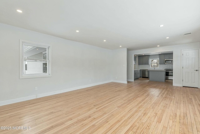 unfurnished living room with light wood-type flooring