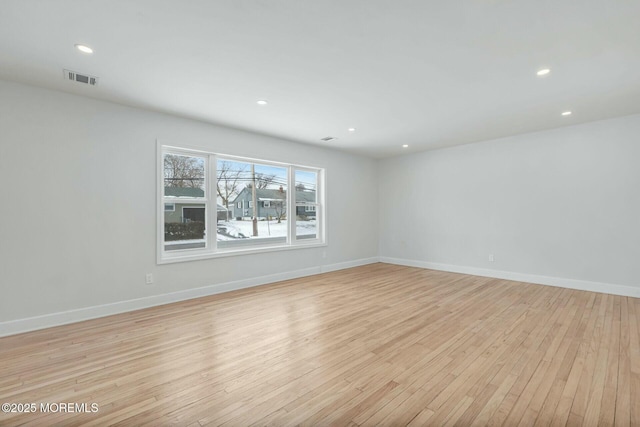 empty room with light hardwood / wood-style floors