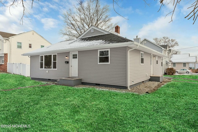 rear view of house featuring a yard