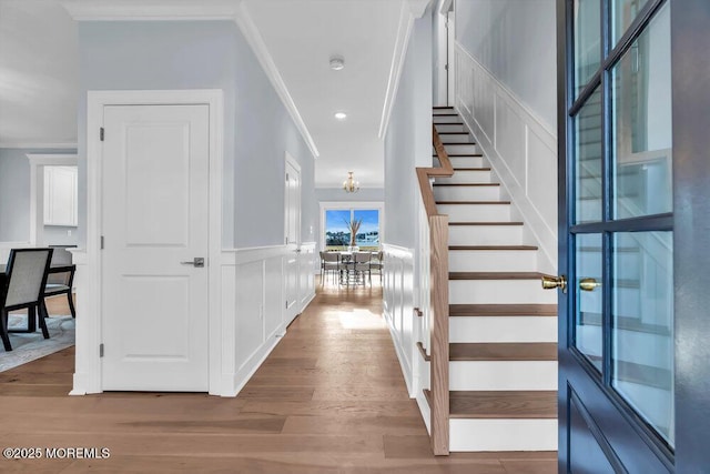 302 Reef Ct, Forked River, NJ 08731 - entryway with ornamental molding, wood finished floors, stairway, a decorative wall, and wainscoting