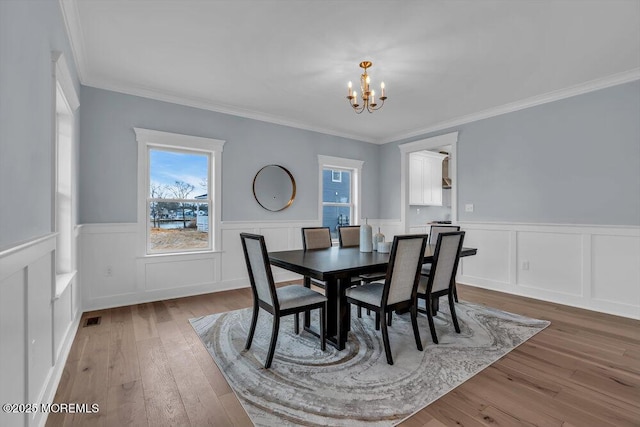 302 Reef Ct, Forked River, NJ 08731 - dining space with a chandelier, wainscoting, hardwood / wood-style flooring, and ornamental molding