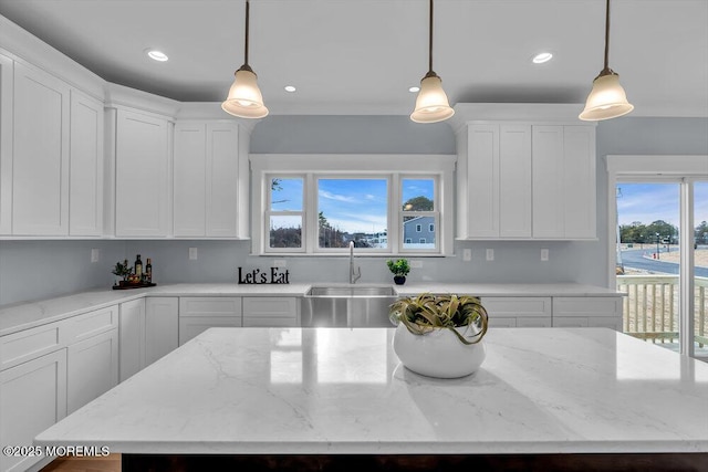 302 Reef Ct, Forked River, NJ 08731 - kitchen featuring white cabinetry, recessed lighting, decorative light fixtures, a kitchen island, and light stone countertops