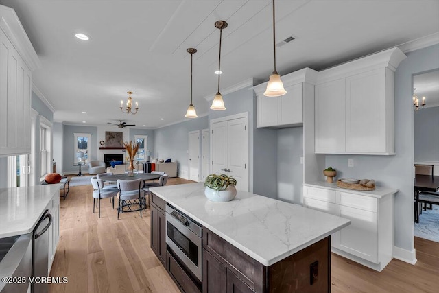 302 Reef Ct, Forked River, NJ 08731 - kitchen with a chandelier, light wood-type flooring, ornamental molding, white cabinetry, and stainless steel appliances