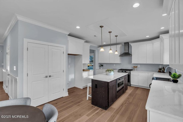 302 Reef Ct, Forked River, NJ 08731 - kitchen with wall chimney range hood, stainless steel appliances, crown molding, white cabinetry, and a center island