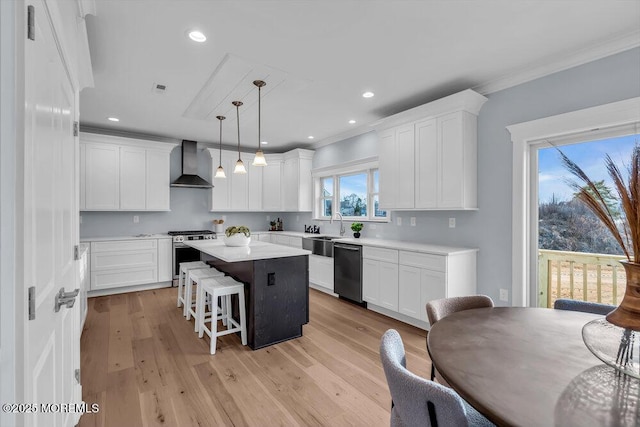 302 Reef Ct, Forked River, NJ 08731 - kitchen with wall chimney range hood, appliances with stainless steel finishes, a center island, white cabinets, and a kitchen breakfast bar