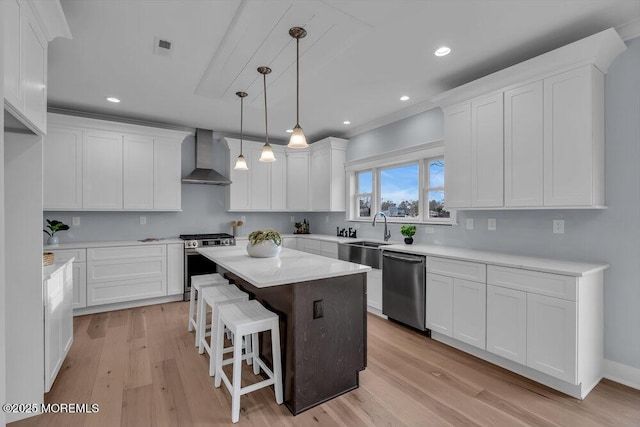 302 Reef Ct, Forked River, NJ 08731 - kitchen with stainless steel appliances, wall chimney exhaust hood, white cabinets, light wood-style flooring, and recessed lighting