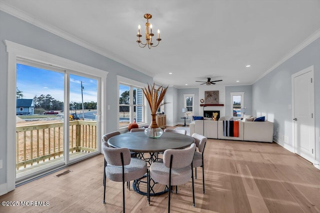 302 Reef Ct, Forked River, NJ 08731 - dining area with ornamental molding, a chandelier, a fireplace, light wood finished floors, and recessed lighting
