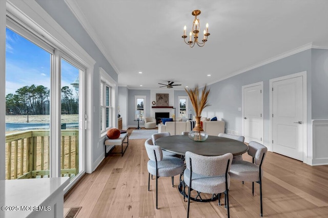302 Reef Ct, Forked River, NJ 08731 - dining room featuring ornamental molding, light wood-style floors, a fireplace, a chandelier, and recessed lighting