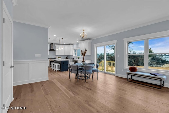 302 Reef Ct, Forked River, NJ 08731 - dining area featuring crown molding, a chandelier, light wood finished floors, and wainscoting