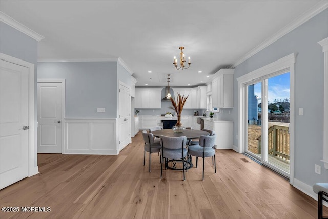 302 Reef Ct, Forked River, NJ 08731 - dining area featuring light wood finished floors, a chandelier, crown molding, a wainscoted wall, and recessed lighting