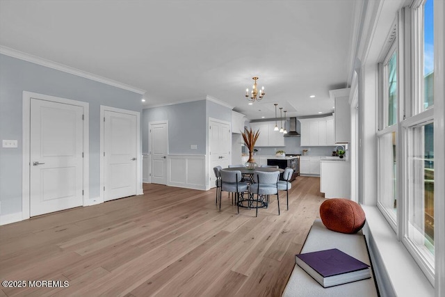 302 Reef Ct, Forked River, NJ 08731 - dining area featuring a chandelier, crown molding, light wood-type flooring, recessed lighting, and a wainscoted wall