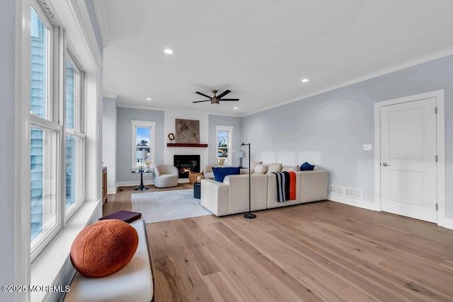 302 Reef Ct, Forked River, NJ 08731 - living area featuring crown molding, ceiling fan, light wood-type flooring, recessed lighting, and a fireplace