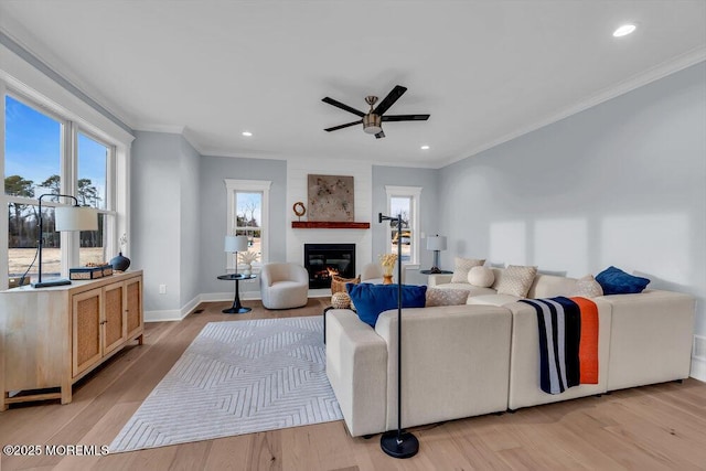 302 Reef Ct, Forked River, NJ 08731 - living area with a ceiling fan, crown molding, healthy amount of natural light, a large fireplace, and light wood finished floors