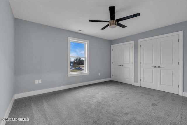 302 Reef Ct, Forked River, NJ 08731 - unfurnished bedroom featuring multiple closets, carpet, and a ceiling fan