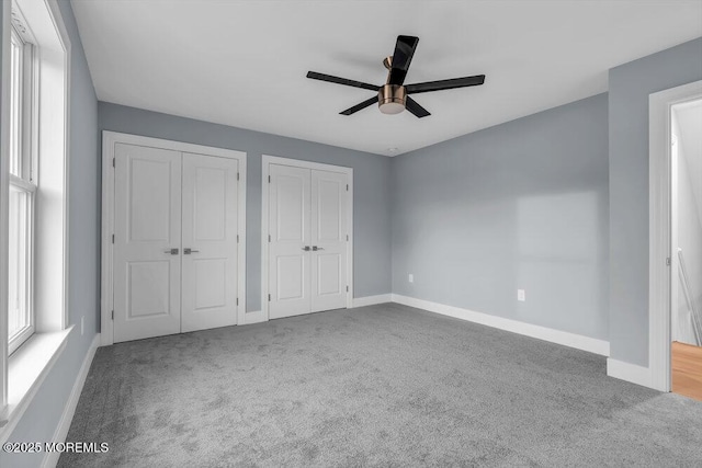 302 Reef Ct, Forked River, NJ 08731 - unfurnished bedroom with multiple closets, carpet floors, and ceiling fan