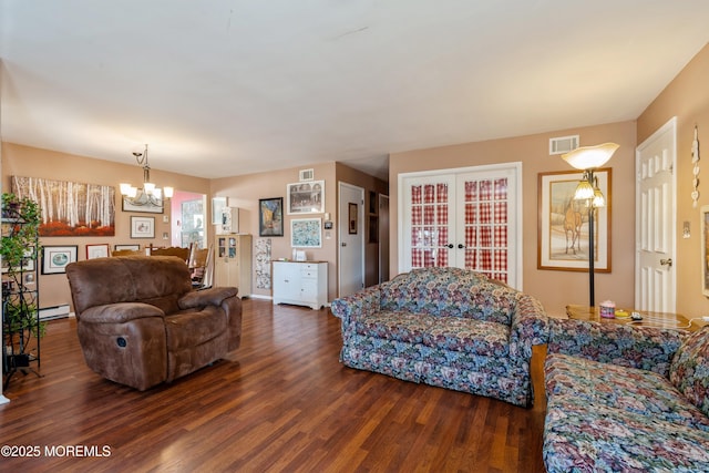 living room with a baseboard radiator, an inviting chandelier, dark hardwood / wood-style flooring, and french doors