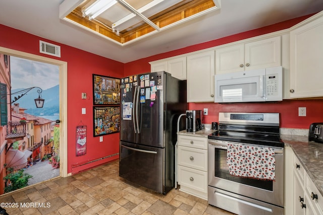 kitchen featuring white cabinetry, stone countertops, and appliances with stainless steel finishes