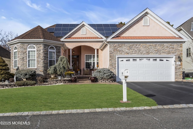 view of front of house featuring a garage, covered porch, a front lawn, and solar panels