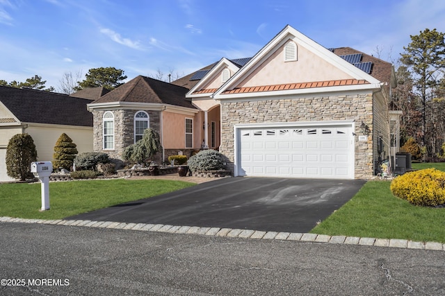 view of front of house with a garage and a front lawn