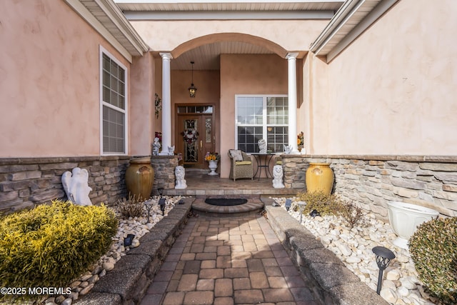 view of exterior entry with a porch