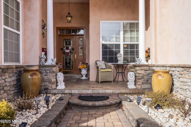 view of exterior entry with covered porch