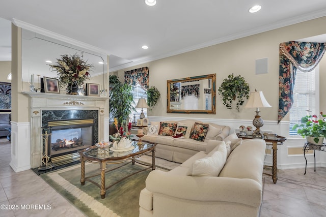 living room with crown molding and a high end fireplace