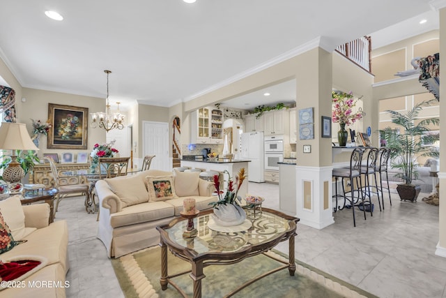 living room with ornamental molding and a notable chandelier