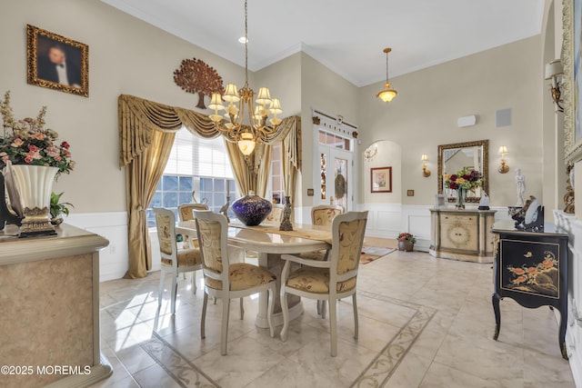 dining area featuring crown molding and a notable chandelier