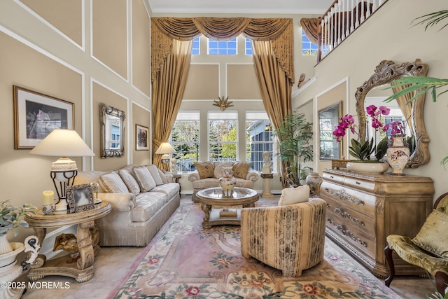 sitting room with a towering ceiling