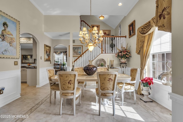 dining space with crown molding, plenty of natural light, and a notable chandelier