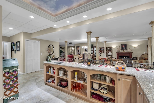 kitchen featuring ornate columns, pendant lighting, a paneled ceiling, light stone countertops, and light brown cabinets