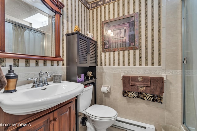 bathroom featuring tile walls, vanity, a baseboard heating unit, toilet, and a shower with shower curtain