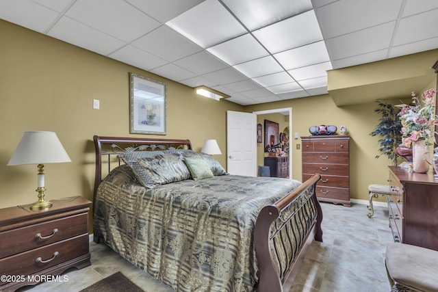 bedroom with a spacious closet and a paneled ceiling