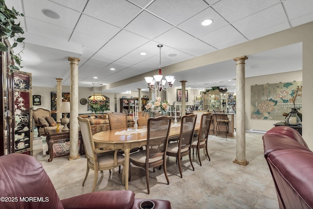 dining room with ornate columns, a baseboard radiator, and a paneled ceiling