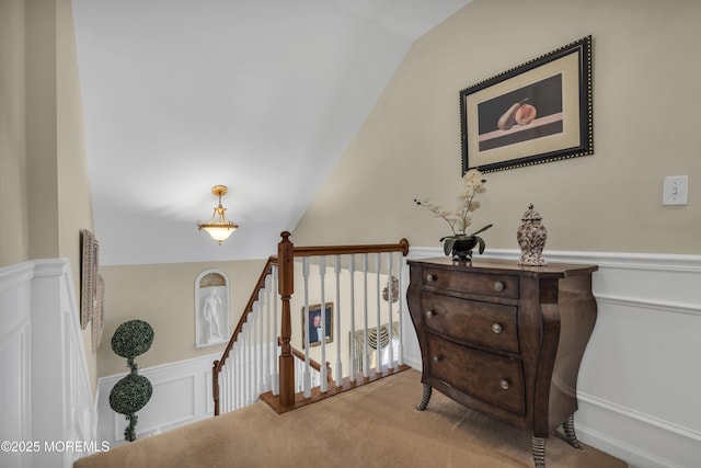 hall with lofted ceiling and carpet floors