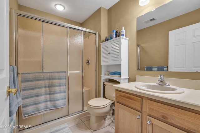 bathroom featuring tile patterned flooring, vanity, an enclosed shower, and toilet