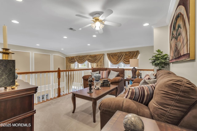 living room featuring crown molding, carpet floors, and ceiling fan