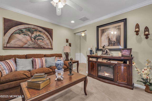 living room with ornamental molding, light colored carpet, and ceiling fan